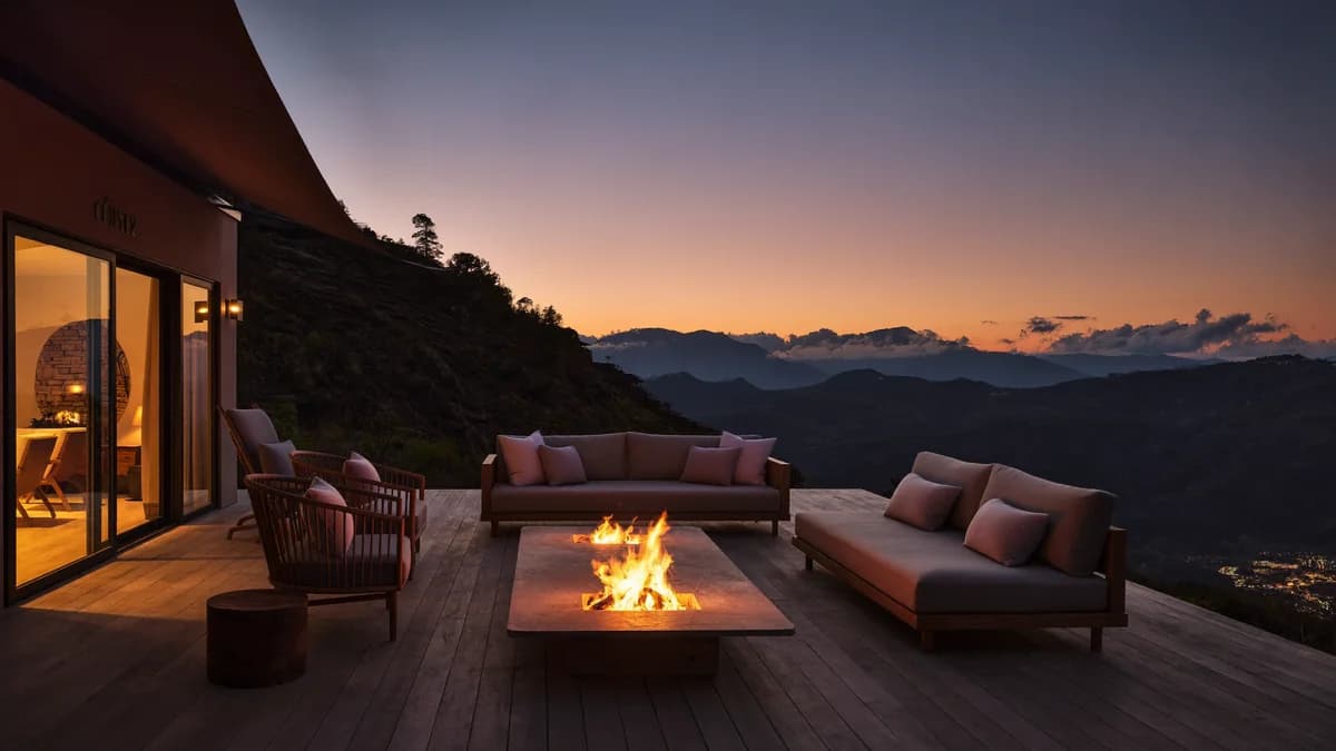 Family sharing quality time at sunset on the wooden deck of a luxury mountain glamping dome by a fire pit