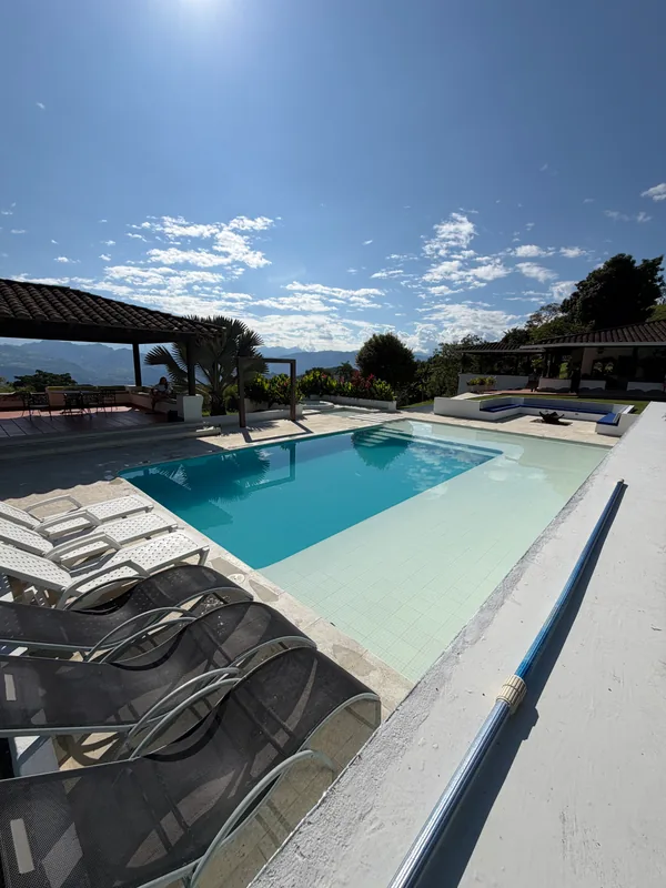 Swimming pool and loungers at La Juana with panoramic views of the mountain range
