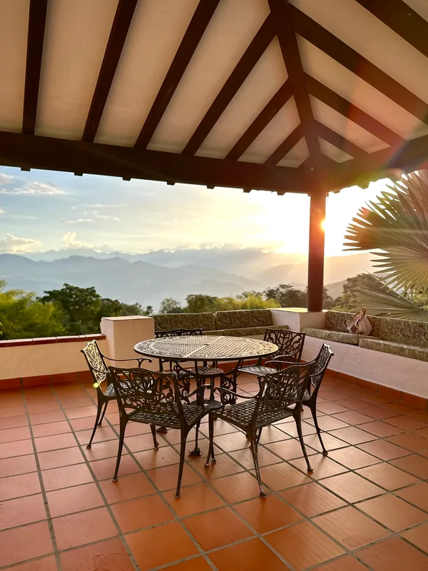 Viewing terrace at La Juana with wrought iron dining table and sunset mountain panorama