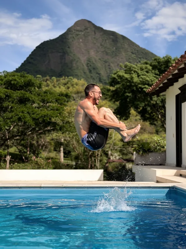 Cannonball jump into the panoramic pool at La Juana with Cerro Tusa directly in the background