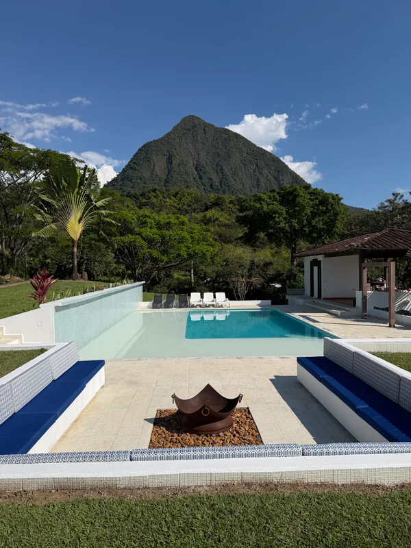 Pool with a fire pit at the center of the farmhouse, family vacation in Medellín with kids at La Juana Cerro Tusa
